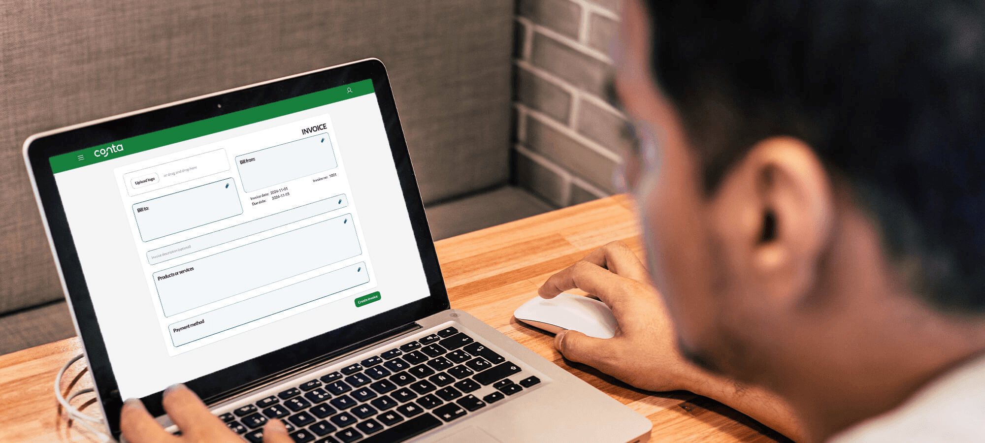 Man viewing digital invoice on laptop - How to Invoice as a Freelancer